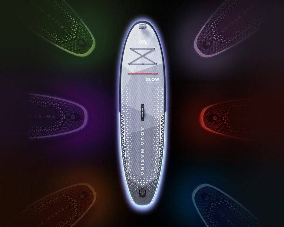 A stand-up paddle board shown vertically on a dark promotional background with glowing multicolor light trails and the text 'LET'S GLOW' on the left.